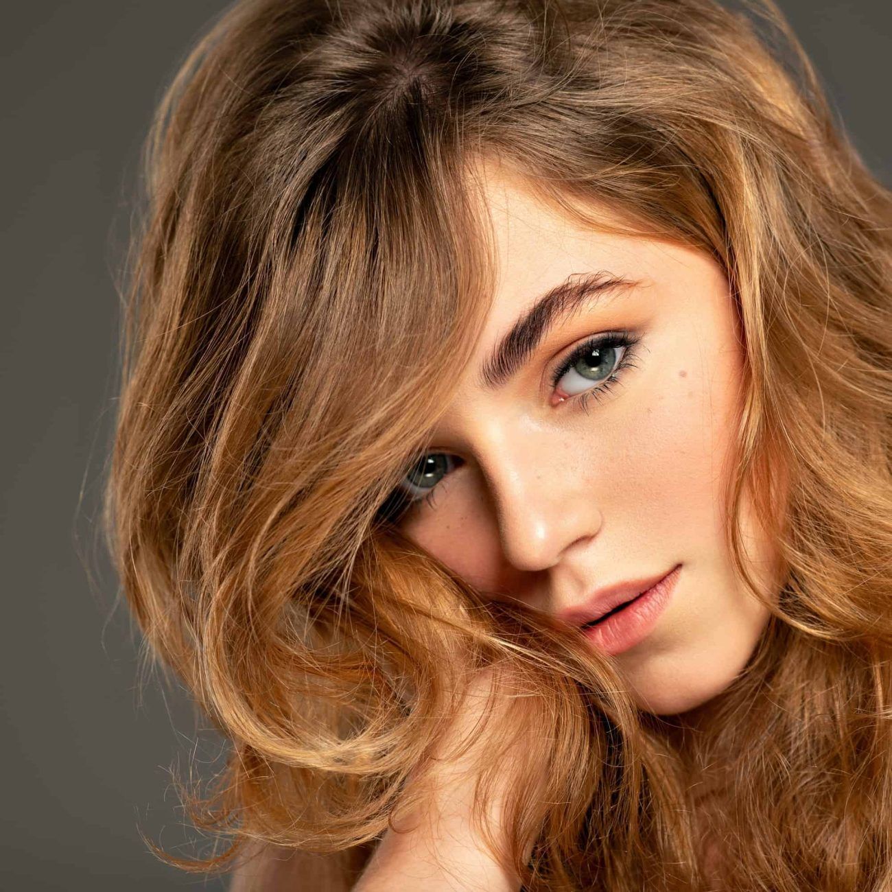 closeup-portrait-of-an-young-adult-girl-with-long-curly-hair-fashion-model